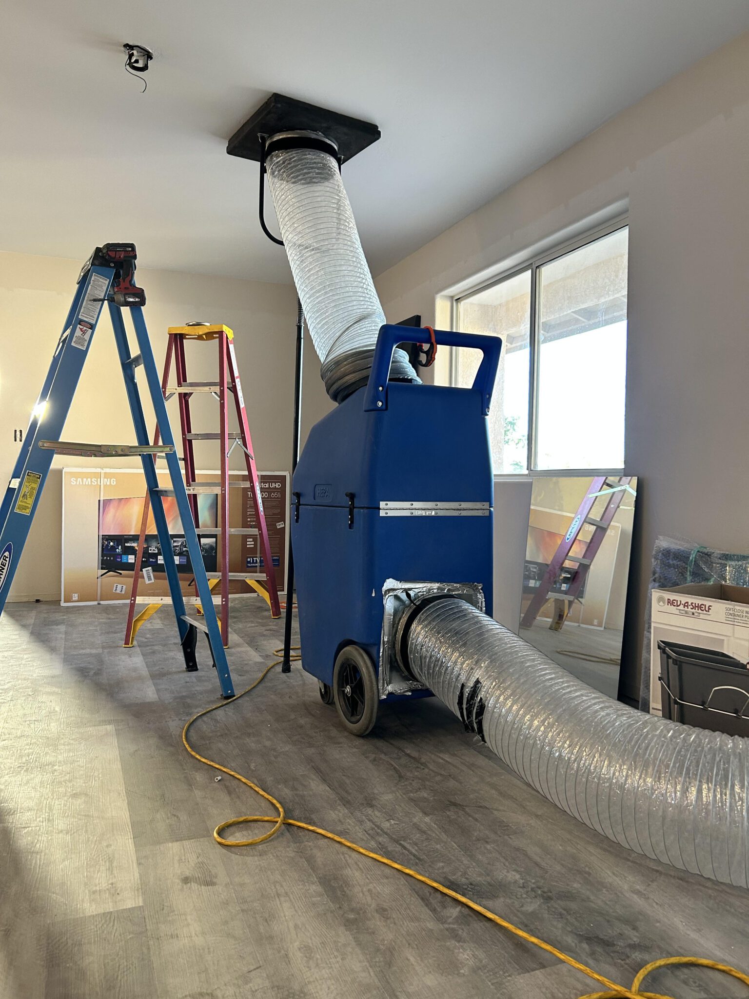 Technician performing air duct cleaning